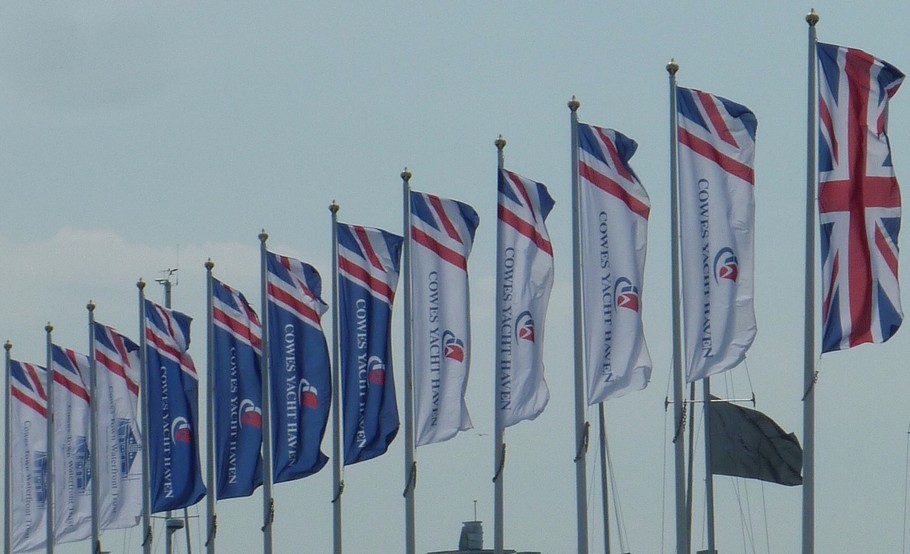 row of flags flying in breeze