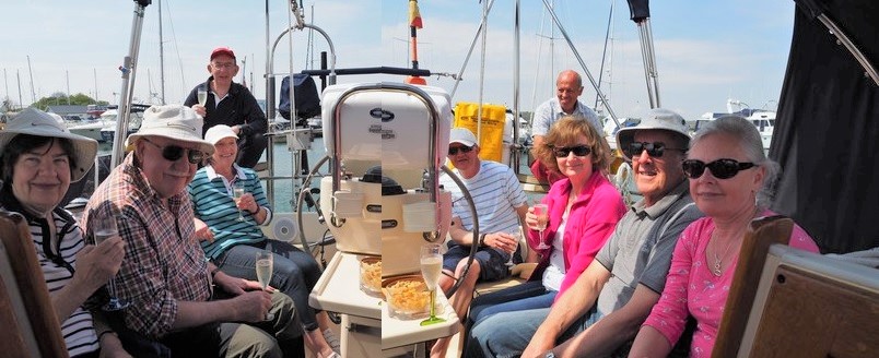 group of friends in cockpit of yacht